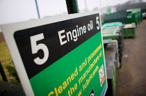 Engine oil recycling information sign at a recycling centre, Stroud, Gloucestershire, UK, February 2008.
