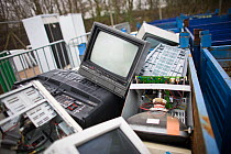 Close up of computer monitors and televisionsets  in containers at a recycling centre, Stroud, Gloucestershire, UK, February 2008.
