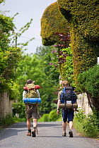 Walkers carrying backpacks on the Cotswold Way National Trail at Painswick, Gloucestershire, UK, May 2008.