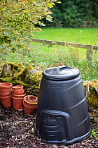 A garden compost bin with stacked flower pots next to it, September 2008.