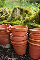 A stack of unused plant pots in a garden, UK, September 2008.