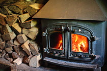 Log burning stove inside The Plough Inn, Ford, Cheltenham, Gloucestershire, UK, October 2008.