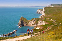 Walkers on the South West Coast Path National Trail near Durdle Door, Dorset, UK, May 2009.