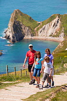 Family walking on the South West Coast Path National Trail near Durdle Door, Dorset, UK, May 2009.