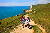 Family walking on the South West Coast Path National Trail near Durdle Door, Dorset, UK, May 2009.