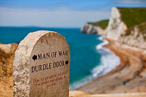 Waymarker information sign at Durdle Door on the South West Coast Path National Trail, with coastline in the background, Dorset, UK, May 2009.
