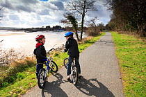 Children on The Tarka Trail cycle path, Devon, UK, March 2010.