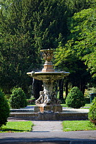 Water fountain and trees in city park in summer, Cheltenham, Gloucestershire, UK, June 2011.