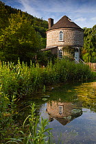The Roundhouse at Chalford and reflection in the Stroudwater Canal, Gloucestershire, UK, June 2011.