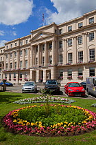 The Promenade building with formal flowerbeds outside the front entrance , Cheltenham, Gloucestershire, UK, July 2011.