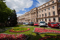 The Promenade building with formal  flowerbeds outside the front entrance, Cheltenham, Gloucestershire, UK, July 2011.