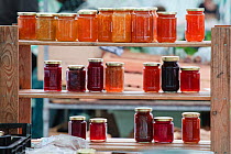 Preserves on a shelf for sale at Cirencester Farmers Market, Cirencester, Gloucestershire, UK, July 2011.