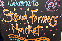 Blackboard welcome information sign within Stroud Farmers Market, Stroud, Gloucestershire, UK, August 2011.