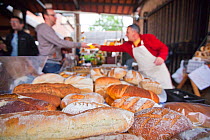 Man selling bread at the Stroud Farmers Market, Stroud, Gloucestershire, UK, August 2011.