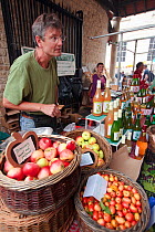 Man serving hand picked heritage apples and juice at Stroud Farmers Market, Stroud, Gloucestershire, UK, August 2011.