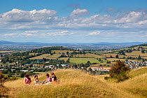Women and children having a picnic high up on Selsley Common unimproved grassland, Stroud, Gloucestershire, UK, August 2011. Model released