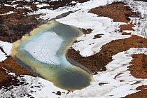 Aerial view of partially frozen tundra, with meltwater pool, Taimyr Peninsula, Siberia, Russia, June 2010