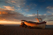 Fishing boat at sunset, Weybourne beach, Norfolk, UK