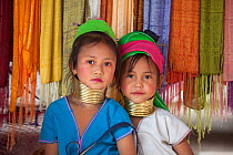 Two young girls with neck rings to extend their necks,  belonging to Padaung Tribe, Thailand