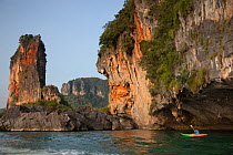 Rock formations at Ao Phra Nang with kayaker, Andaman sea, Thailand