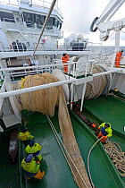 Crew of the pelagic trawler 'Charisma' working the nets, Shetland Islands, Scotland, UK, October 2011 Model Releae available