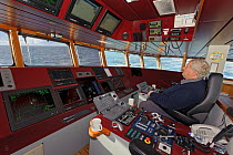 Skipper David Hutchison on the bridge of the pelagic trawler 'Charisma', Shetland Islands, Scotland, UK, October 2011 Model Release available