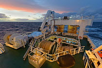 Crew working at dusk on deck of the pelagic trawler 'Charisma', Shetland Islands, Scotland, UK, October