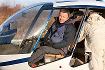 Photographer Peter Cairns preparing for helicopter flight over Glenfeshie whilst on assignment for 2020VISION, Cairngorms National Park, Scotland, UK, January 2012. Model released
