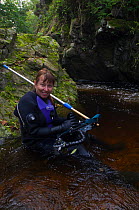 2020VISION photographer Linda Pitkin photographing Brown trout (Salmo trutta) and Atlantic salmon (Salmo salar) using an underwater polecam, River Tweed, Cheviot Hills, Northumberland, England, UK, Oc...