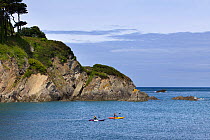 Two kayakers in Lee Bay, Devon, England, UK, May 2011
