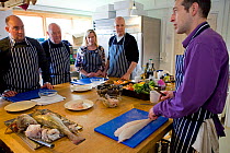 Group of people on a seafood cookery course run by Dorset-based Fraser Christian. People learn about fish and shellfish cookery skills with an emphasis on locally-caught sustainable species, Dorset, E...