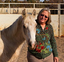 Carol Walker training her second year male palomino Wild horse / mustang colt, Mica,  that had been rounded up from the Adobe Town herd, Wyoming, and put up for adoption, Colorado, USA, March 2011, mo...