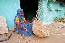 Village life with an elderly woman making basket, Bayana, Rajasthan, India