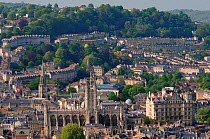 Overview of Bath city showing Bath Abbey and crescents of terraced houses following contours of the hills, UK, April 2011.