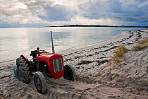 Tractor on middle town beach, St. Martin's, Isles of Scilly, UK, January 2011.