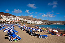 Sun loungers lined up on the artifical beach at Los Cristianos, near Playa de las Americas, Tenerife, Canary Islands, April 2011.