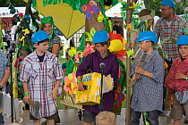 Children and adults taking part in tropical rainforest play as part of a Folk Festival, celebrating the life of a forest and its people, documenting the threat from loggers and its imminent destructio...
