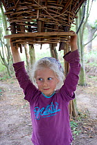Child discovering wooden sculpture in Onny Meadows,local nature reserve,Shropshire, UK 2011