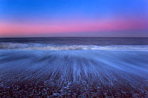 Cley Beach with retreating wave patterns, after sunset,  Norfolk, UK January