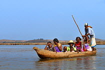 Malagasy family in dugout  canoe, Tsiribihina River, Madagascar 2008.