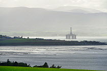 Udale Bay RSPB reserve showing oil drilling platform moored in background, Cromarty Firth, Scotland, June 2009