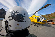 Helicopter Pilot Peter Garden from behind with his helicopter, South Georgia Heritage Trust Rat Eradication Project, Grytviken, South Georgia, March 2011