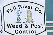 Sign for a pest control company. Indigenous prairie dogs were exterminated in the area throughout the 20th century to protect crops. Custer, South Dakota, March 2002.