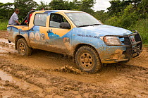 Conservation officers on muddy road during survey of Blue throated / Wagler's macaw (Ara glaucogularis) Trinidad, Beni, Bolivia, Critically endangered species, January 2008.