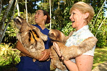 Judy Avey-Arroyo, sloth refuge owner, and volunteer holding Brown Throated Three Toed Sloth (Bradypus variegatus) Aviarios del Caribe Sloth Refuge, Costa Rica, 2008.