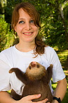 Volunteer holding Hoffman's Two Toed Sloth (Choloepus hoffmanni) Aviarios del Caribe Sloth Refuge, Costa Rica, 2008.