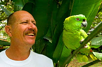 Juan Jose Rojas, zoo director at La Marina Wildlife Rescue Centre, with a Yellow-naped Parrot (Amazona auropalliata). Costa Rica, 2008.