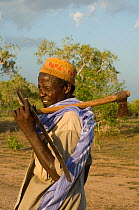 Man with axe, returning from gathering fire wood. Ishaqbini Reserve, Kenya, 2009.
