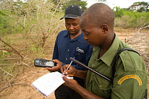 Rangers using a GPS to note their position. Ishaqbini Reserve, Kenya, 2009.