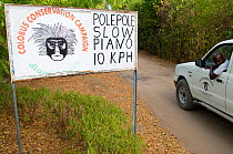 Road sign warning road-users to slow down in areas where Colobus Monkeys live. Ukunda, Diani Beach, Kenya.